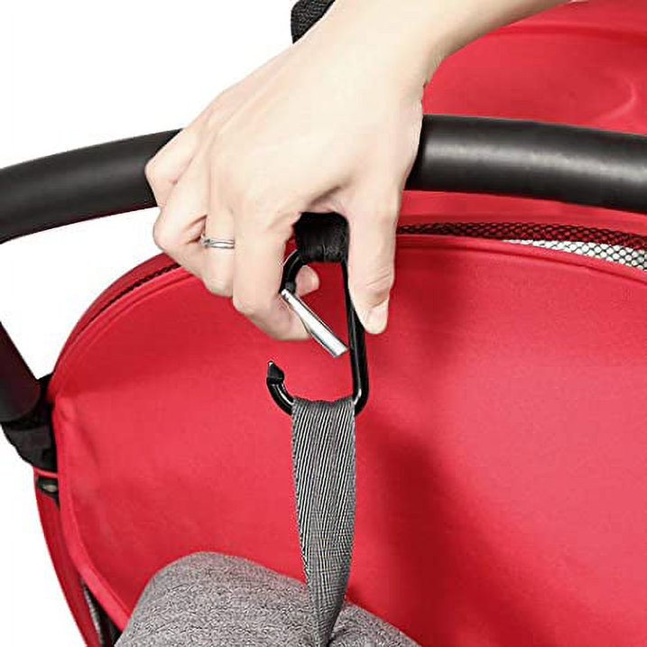 a hand holding a strap to a stroller