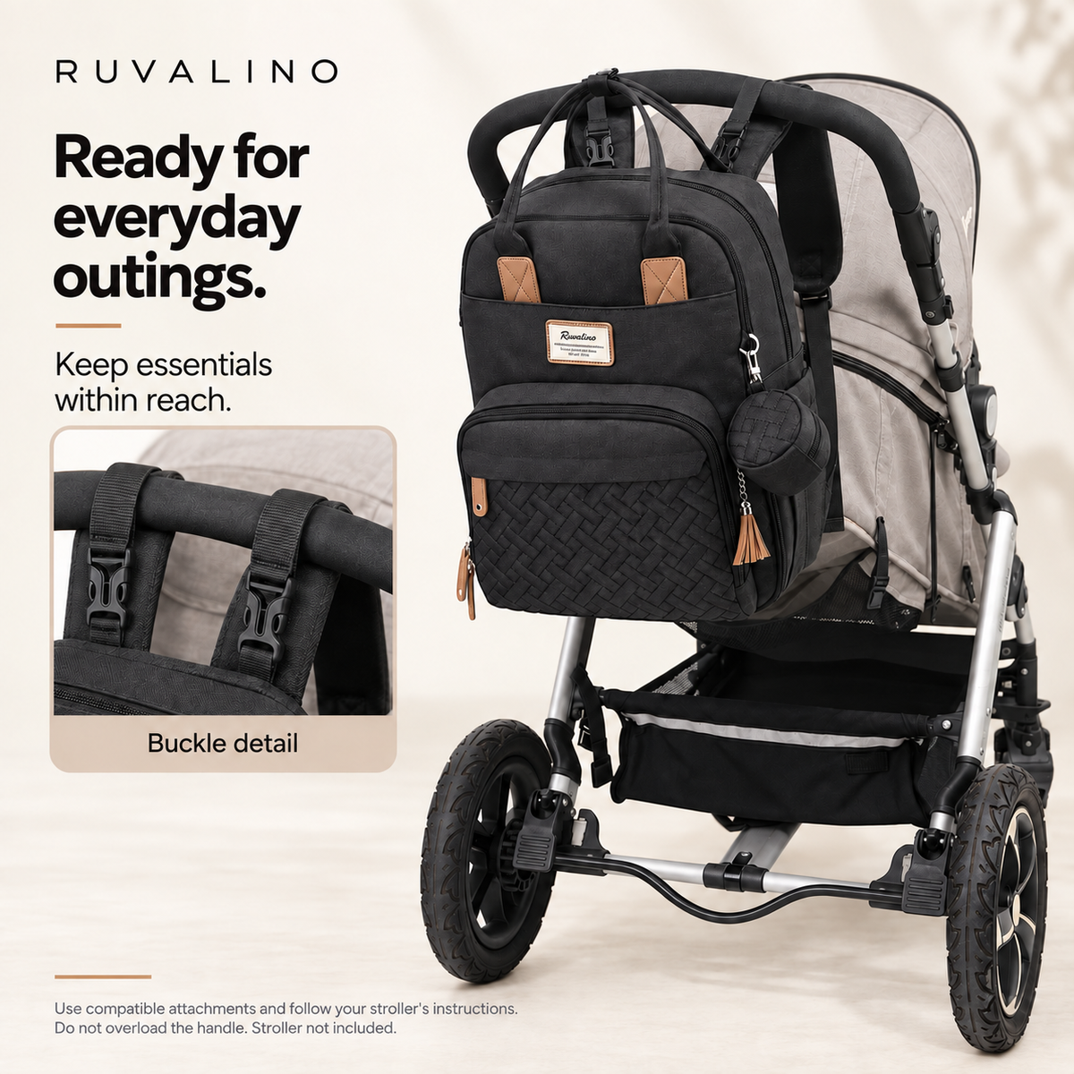RUVALINO Black diaper backpack attached to a stroller with buckle detail; follow compatible stroller instructions