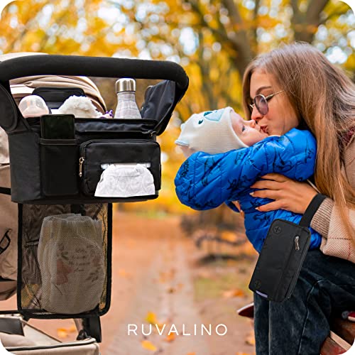 a person holding a baby with text: 'RUVALINO'