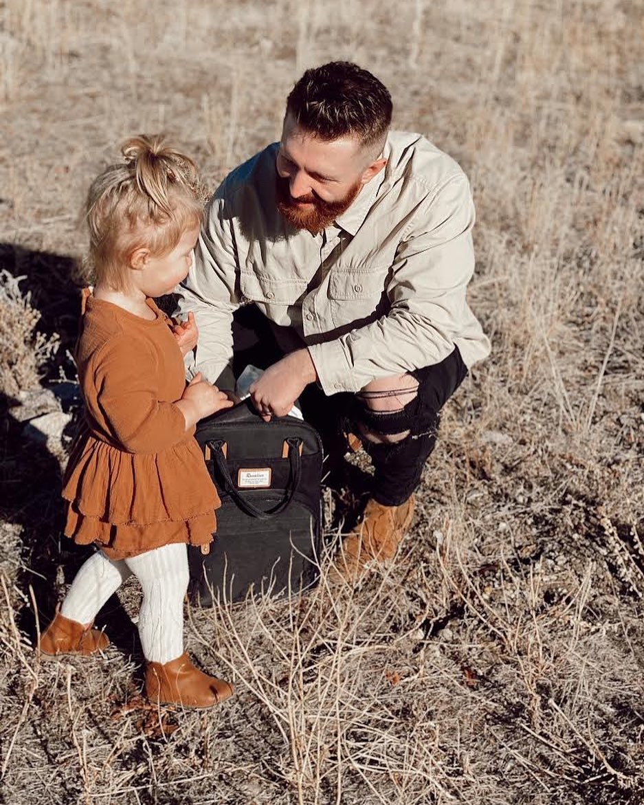 a little girl and her dad looking at each other