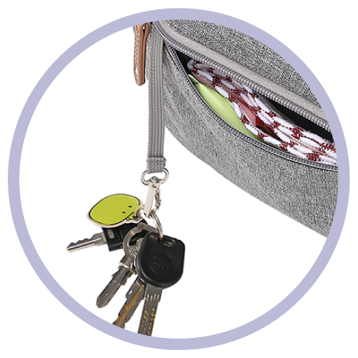 a key strap holding keys attached to a gray backpack