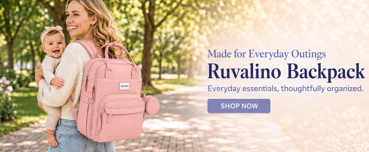 Mother holding her baby with a pink Ruvalino diaper backpack in a park. Made for Everyday Outings. Shop now.