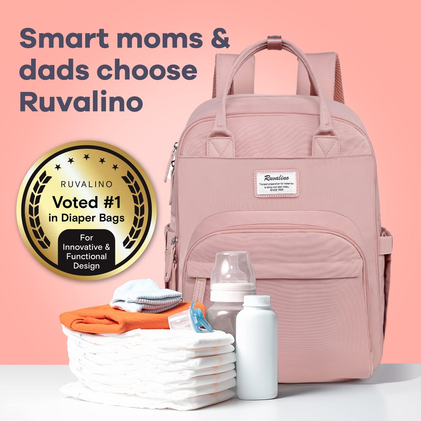 a pink backpack with baby items on a table with text: 'Smart moms & dads choose Ruvalino Ruvalino RUVALINO preparation is doing your best today. SINCE 1985 Voted #1 in Diaper Bags For Innovative & Functional Design'